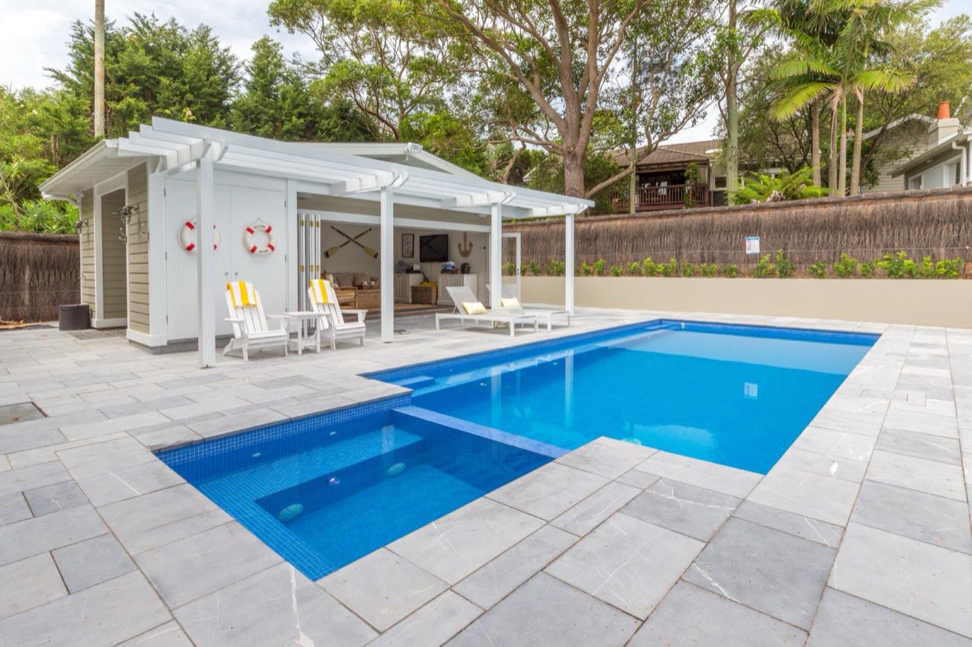 Concrete pool, spa and white cabana by Wright Pools at a Vaucluse home